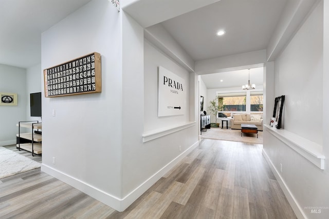 20513 N Glenisla Ave, Boise, ID 83714 - hallway featuring recessed lighting, a notable chandelier, baseboards, and wood finished floors