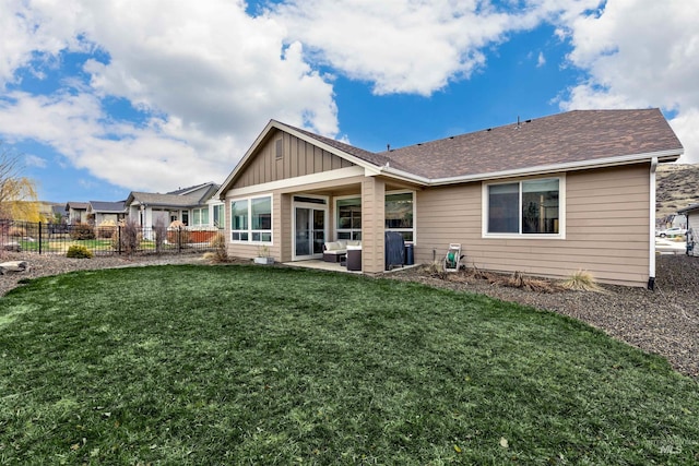 20513 N Glenisla Ave, Boise, ID 83714 - rear view of house with fence, a patio, board and batten siding, a shingled roof, and a yard