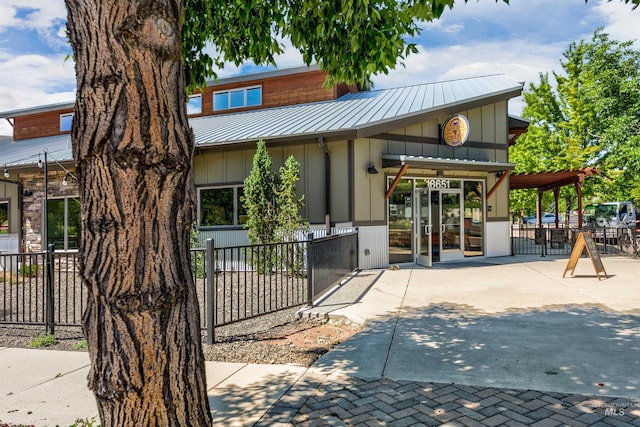 20513 N Glenisla Ave, Boise, ID 83714 - view of front of property featuring french doors, metal roof, fence, and board and batten siding
