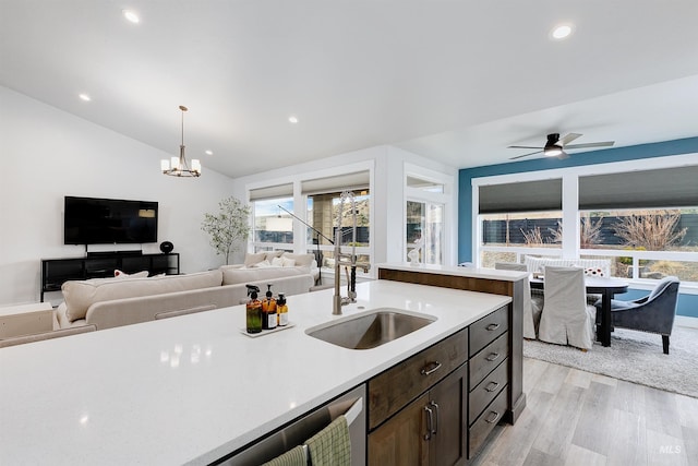 20513 N Glenisla Ave, Boise, ID 83714 - kitchen with open floor plan, light countertops, vaulted ceiling, a sink, and light wood-style floors