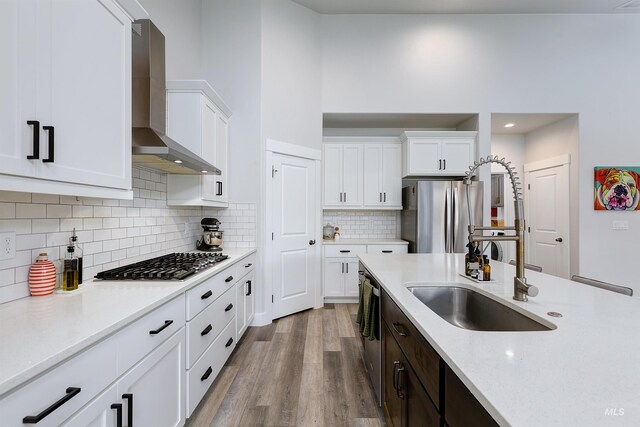 20513 N Glenisla Ave, Boise, ID 83714 - kitchen featuring white cabinets, a sink, stainless steel appliances, and wall chimney exhaust hood