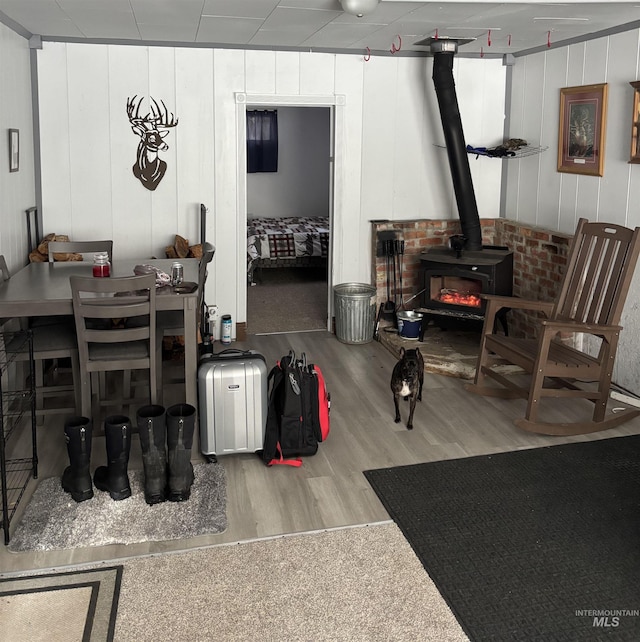 interior space featuring a wood stove and light hardwood / wood-style flooring