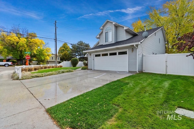 view of side of property featuring a garage and a yard