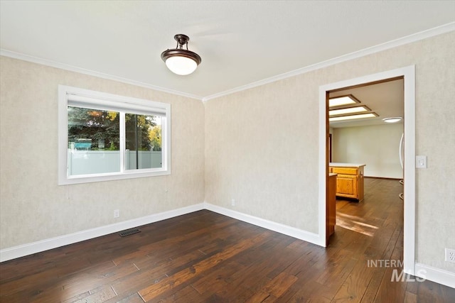 empty room featuring dark hardwood / wood-style floors and ornamental molding