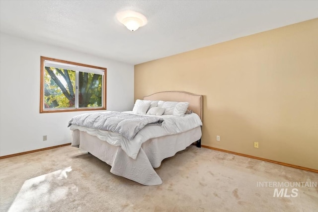 bedroom featuring light colored carpet