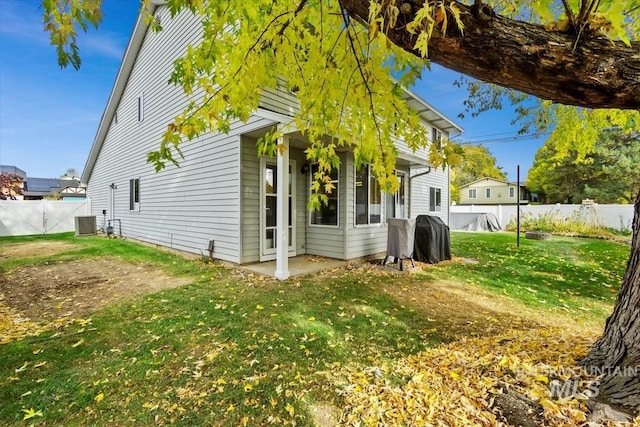 view of home's exterior featuring central AC and a yard