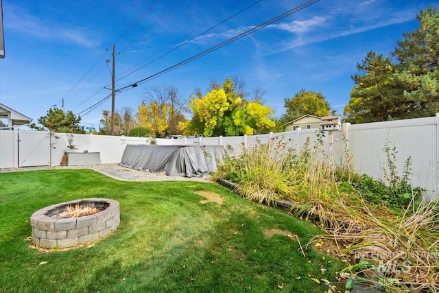 view of yard with an outdoor fire pit