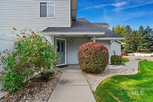 entrance to property featuring a lawn