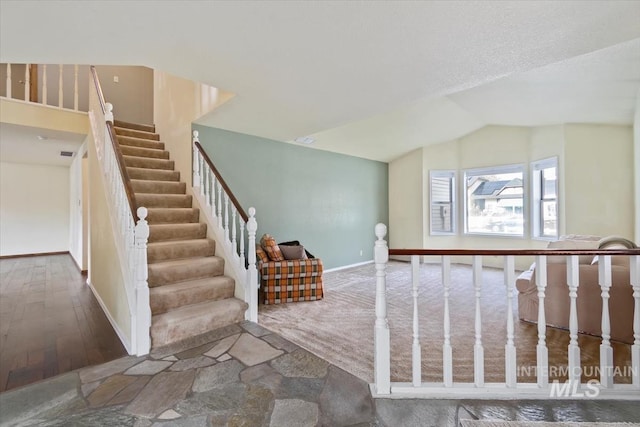 interior space featuring hardwood / wood-style floors and vaulted ceiling