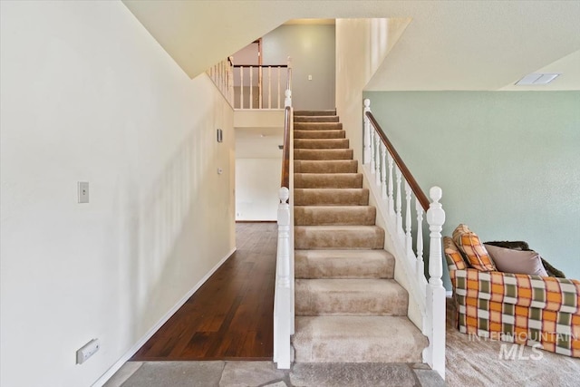 staircase with wood-type flooring