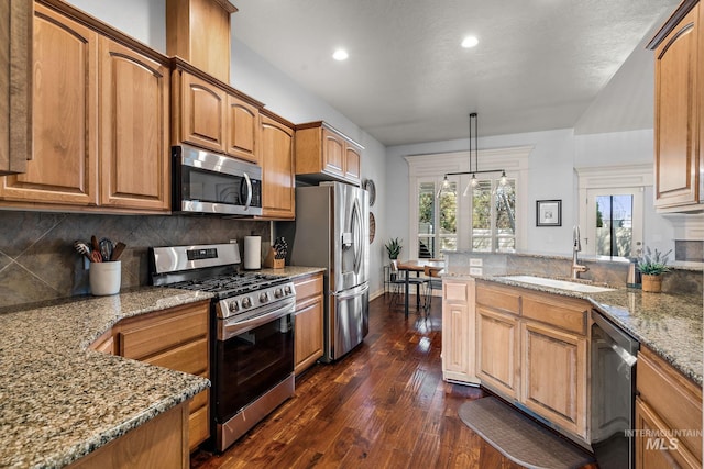 1814 E Grand Canyon Dr, Meridian, ID 83646 - kitchen featuring tasteful backsplash, a sink, light stone counters, stainless steel appliances, and dark wood-type flooring