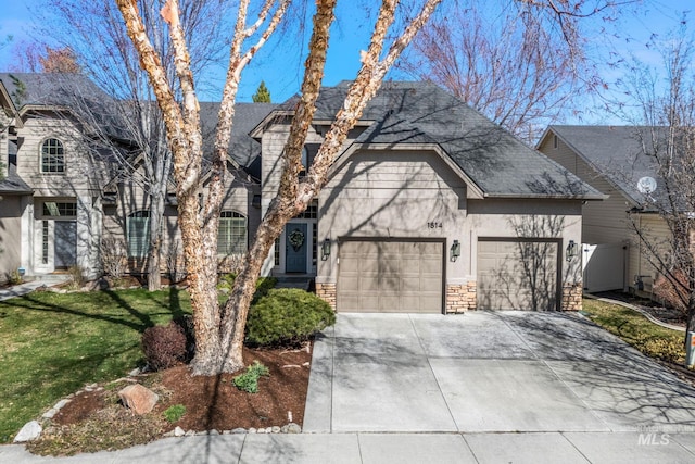 1814 E Grand Canyon Dr, Meridian, ID 83646 - view of front facade with roof with shingles, an attached garage, stone siding, a front yard, and driveway