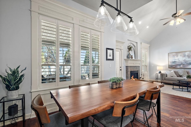 1814 E Grand Canyon Dr, Meridian, ID 83646 - dining space with a ceiling fan, dark wood-style flooring, a fireplace, high vaulted ceiling, and baseboards