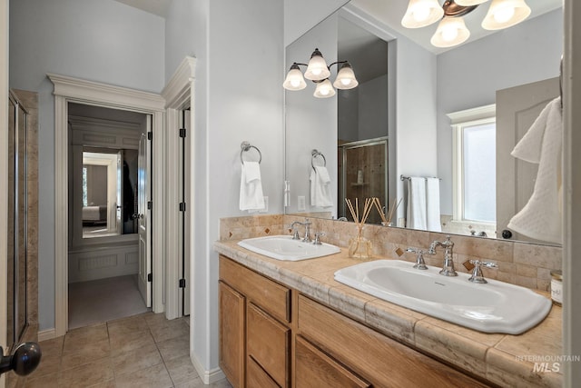 1814 E Grand Canyon Dr, Meridian, ID 83646 - bathroom featuring a sink, tile patterned flooring, an inviting chandelier, and a shower stall