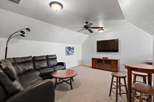1814 E Grand Canyon Dr, Meridian, ID 83646 - carpeted living area with a ceiling fan, a textured ceiling, visible vents, baseboards, and lofted ceiling