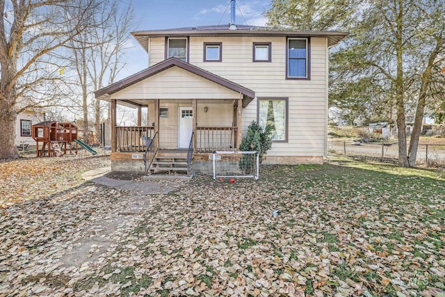 317 W C, Shoshone, ID 83352 - view of front of property featuring covered porch, fence, and a playground