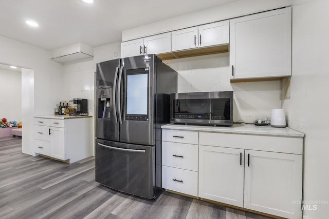 317 W C, Shoshone, ID 83352 - kitchen featuring light countertops, white cabinetry, wood finished floors, and stainless steel appliances