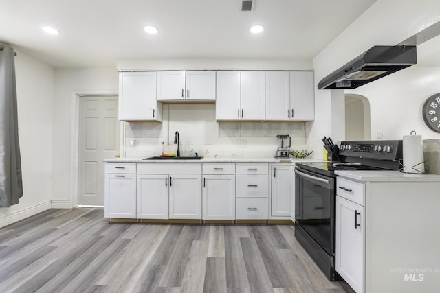 317 W C, Shoshone, ID 83352 - kitchen with a sink, light wood-type flooring, light countertops, under cabinet range hood, and electric stove