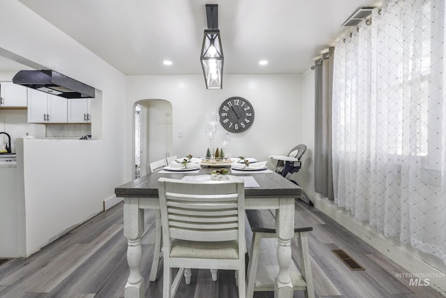 317 W C, Shoshone, ID 83352 - dining space featuring arched walkways, recessed lighting, wood finished floors, and visible vents