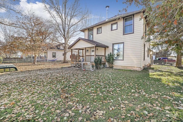 317 W C, Shoshone, ID 83352 - rear view of property featuring a porch, fence, and a yard