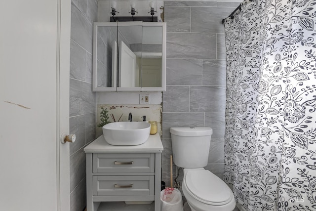 317 W C, Shoshone, ID 83352 - bathroom featuring toilet, tile walls, curtained shower, and vanity