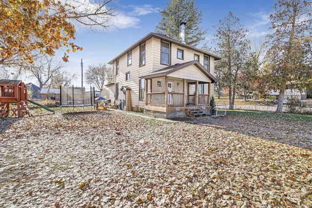 317 W C, Shoshone, ID 83352 - view of front of home featuring a porch, a trampoline, a playground, and fence