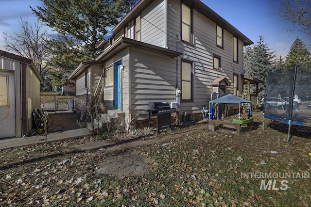 317 W C, Shoshone, ID 83352 - rear view of property with a trampoline and entry steps
