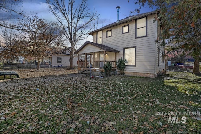 317 W C, Shoshone, ID 83352 - back of house featuring fence, covered porch, and a yard