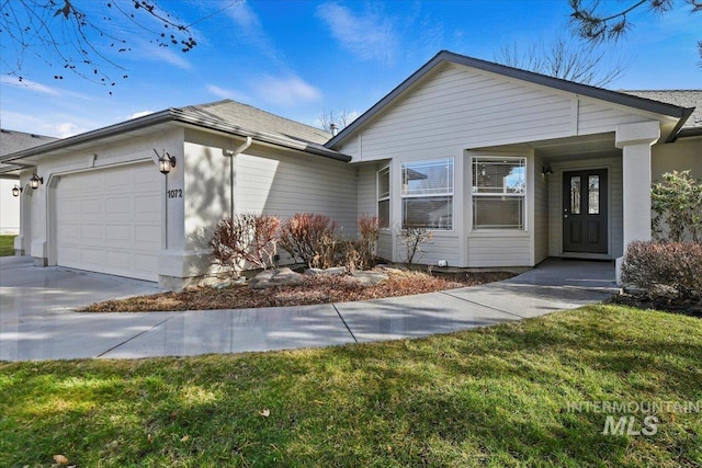 ranch-style home featuring a garage and a front lawn