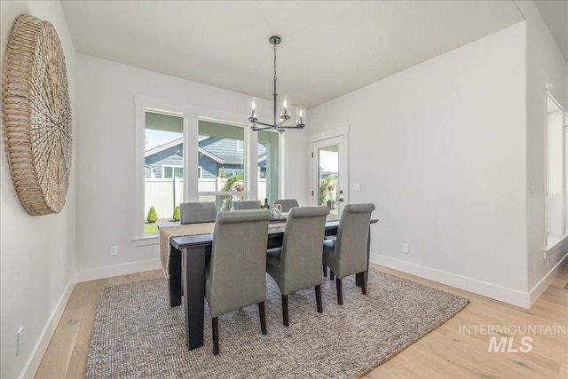 11304 W Helenium Dr, Star, ID 83669 - dining room featuring a chandelier and light wood finished floors