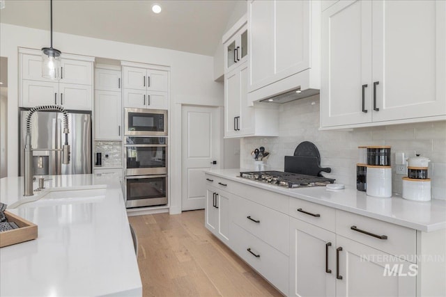 11304 W Helenium Dr, Star, ID 83669 - kitchen with stainless steel appliances, white cabinetry, backsplash, and recessed lighting