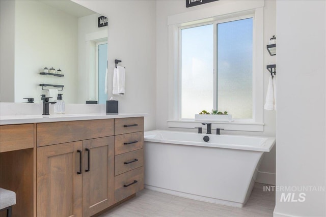 11304 W Helenium Dr, Star, ID 83669 - bathroom featuring a freestanding bath, vanity, and healthy amount of natural light