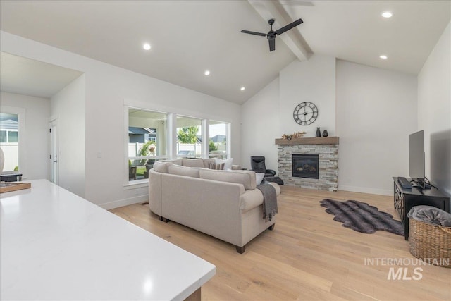 11304 W Helenium Dr, Star, ID 83669 - living area featuring ceiling fan, beamed ceiling, light wood finished floors, a stone fireplace, and recessed lighting