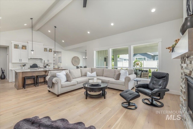 11304 W Helenium Dr, Star, ID 83669 - living area featuring a fireplace, beam ceiling, light wood-type flooring, high vaulted ceiling, and recessed lighting