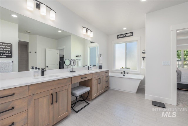 11304 W Helenium Dr, Star, ID 83669 - bathroom with double vanity, a freestanding bath, recessed lighting, and ensuite bathroom