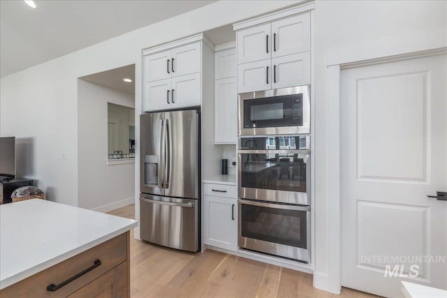 11304 W Helenium Dr, Star, ID 83669 - kitchen with stainless steel appliances, light wood finished floors, light countertops, and recessed lighting