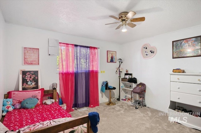 carpeted bedroom featuring ceiling fan and a textured ceiling