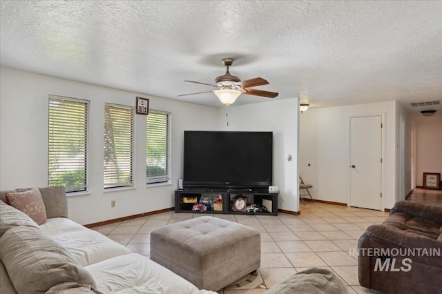 tiled living room with a ceiling fan, baseboards, and a textured ceiling
