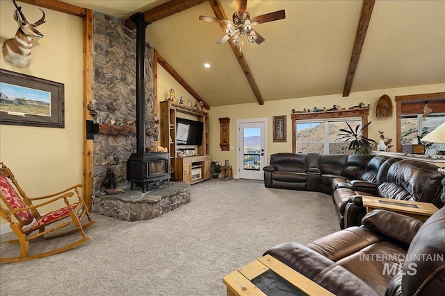 living room featuring high vaulted ceiling, a wood stove, carpet, ceiling fan, and beam ceiling