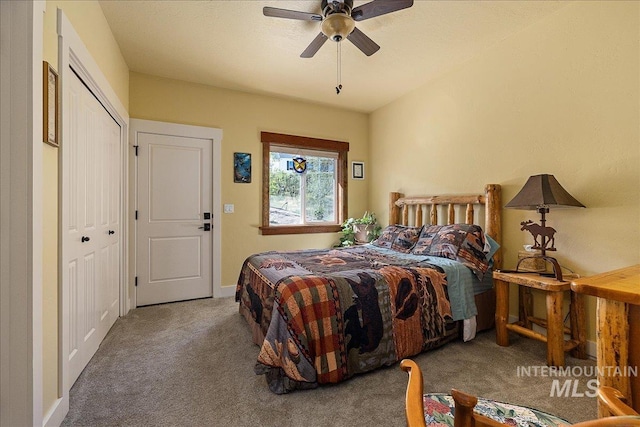 carpeted bedroom featuring ceiling fan and a closet