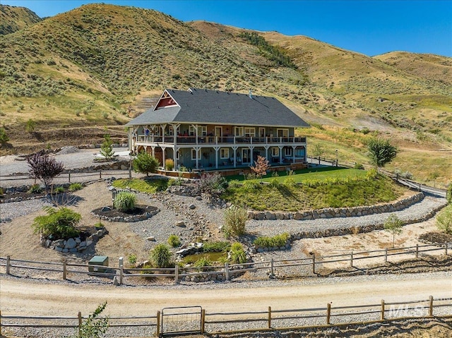 rear view of house featuring a mountain view