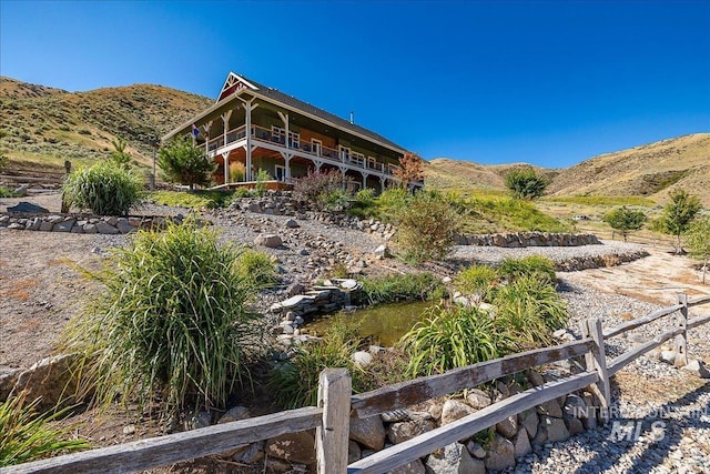 rear view of house with a mountain view