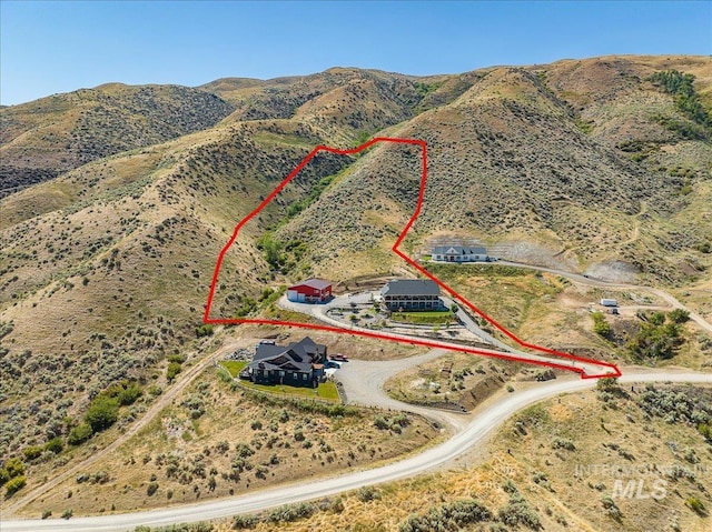 birds eye view of property with a mountain view