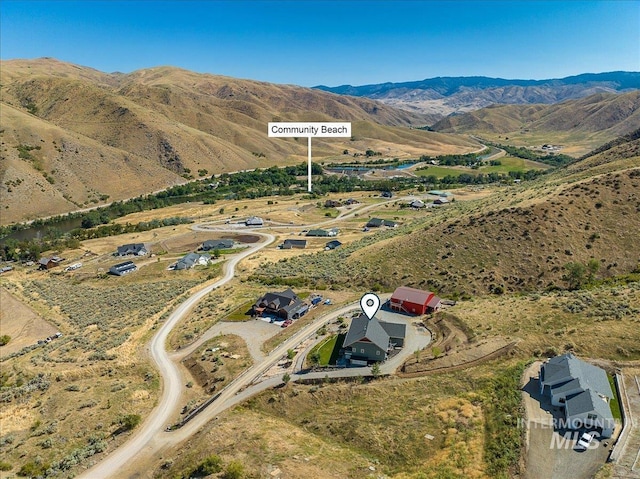 birds eye view of property with a mountain view