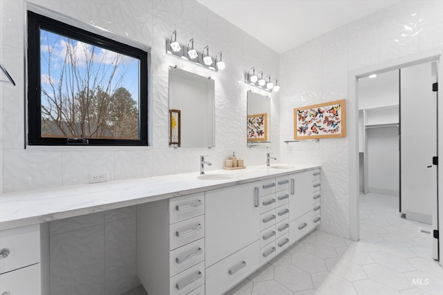 bathroom featuring decorative backsplash, tile patterned floors, vanity, and tile walls