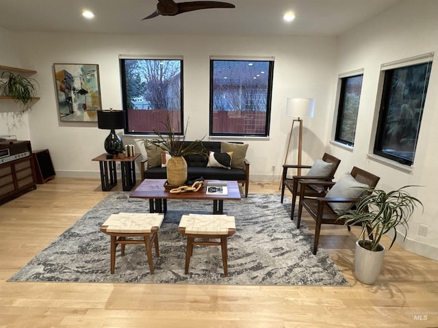 living room with ceiling fan and light wood-type flooring