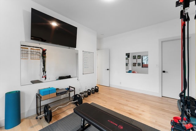 exercise area featuring hardwood / wood-style flooring