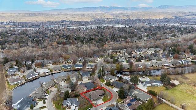 drone / aerial view with a water and mountain view