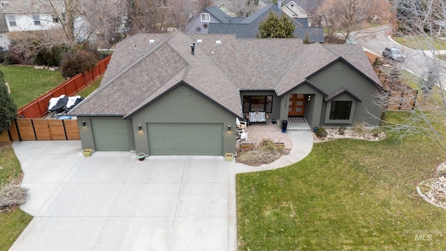 ranch-style home featuring a garage and a front yard