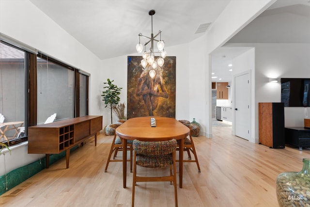 dining area with a chandelier and light hardwood / wood-style floors